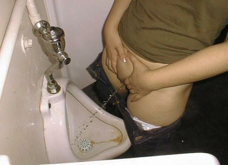 Woman pissing urinal