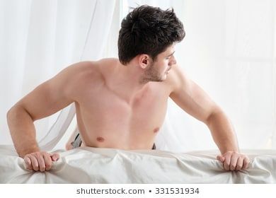 Sexy young men laying in bed nake