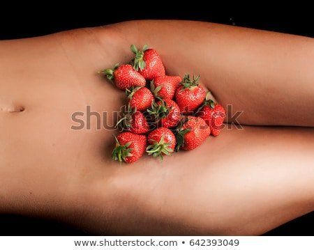 Strawberry on naked woman